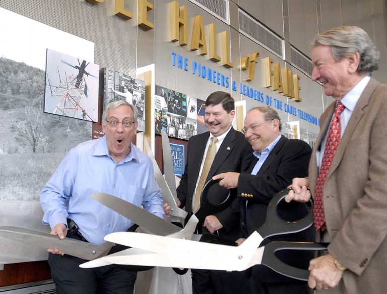 The ribbon cutting for the opening of the Cable Hall of Fame Exhibit, 2008. Left to right, Michael Willner, Larry Satkowiak, Bob Miron, Bill Bresnan.